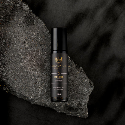 Delune botanical perfume oil roller bottle on dark stone natural fragrance – Ananda Life