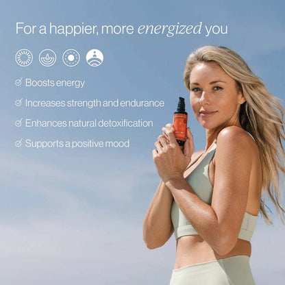 Woman holding a bottle with text about energy, strength, detoxification, and mood improvement against a blue sky.