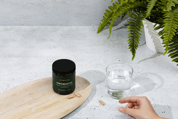 Cymbiotika Probiotic Capsules with a glass of water