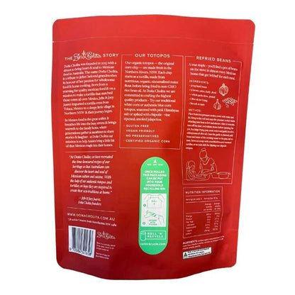Back view of a dona cholita chiptole corn chips packaging with text and branding on a white background