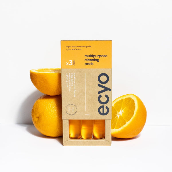 Box of ecyo multipurpose cleaning pods with oranges on a white background