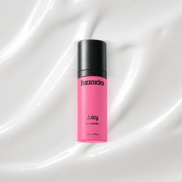 Juicy Face Hydrator bottle on a coloured background