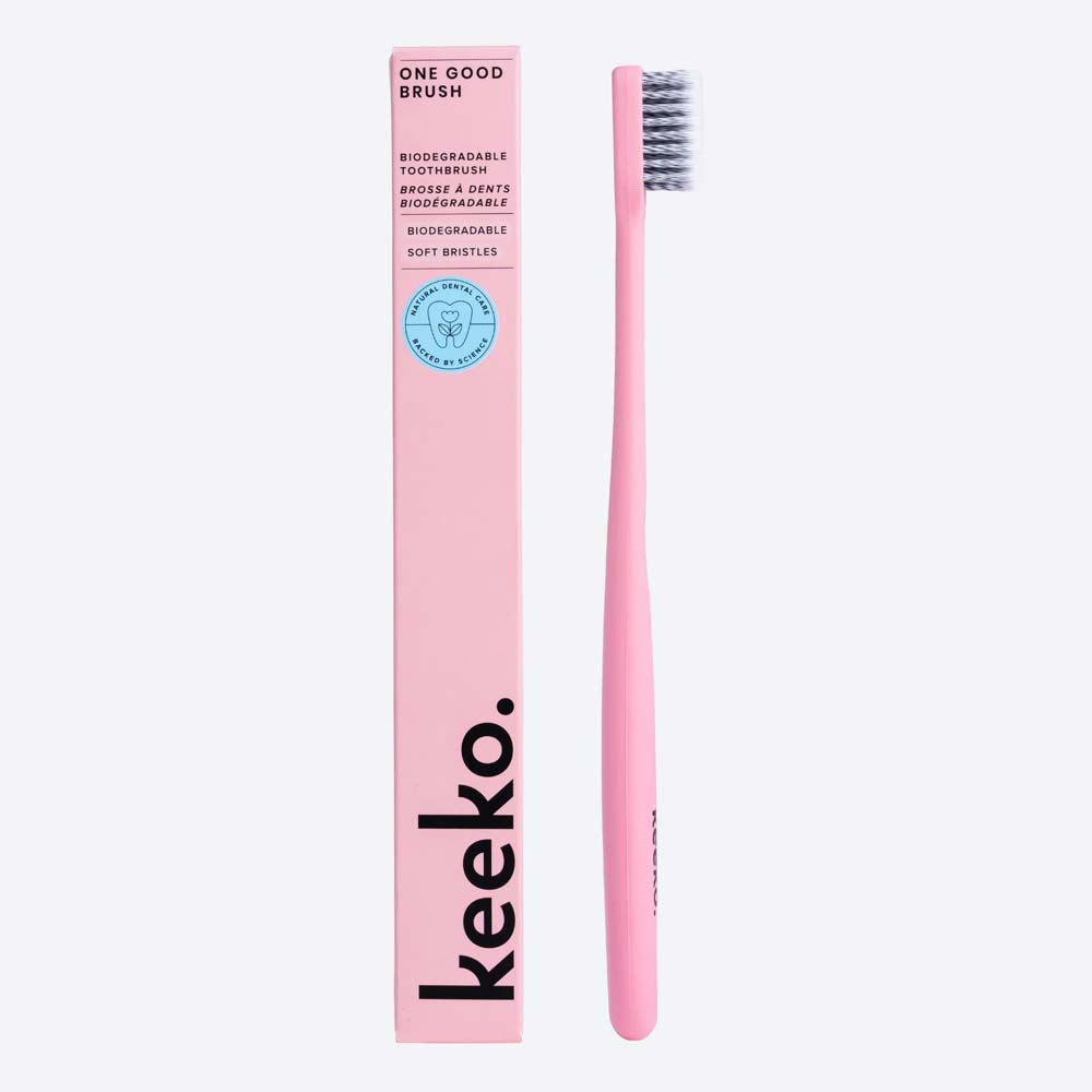 Pink bio toothbrush with packaging labeled 'keeko' on a white background