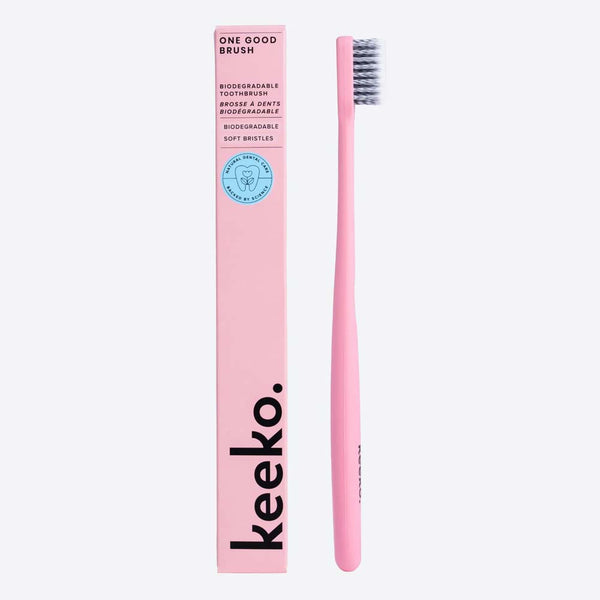 Pink bio toothbrush with packaging labeled 'keeko' on a white background
