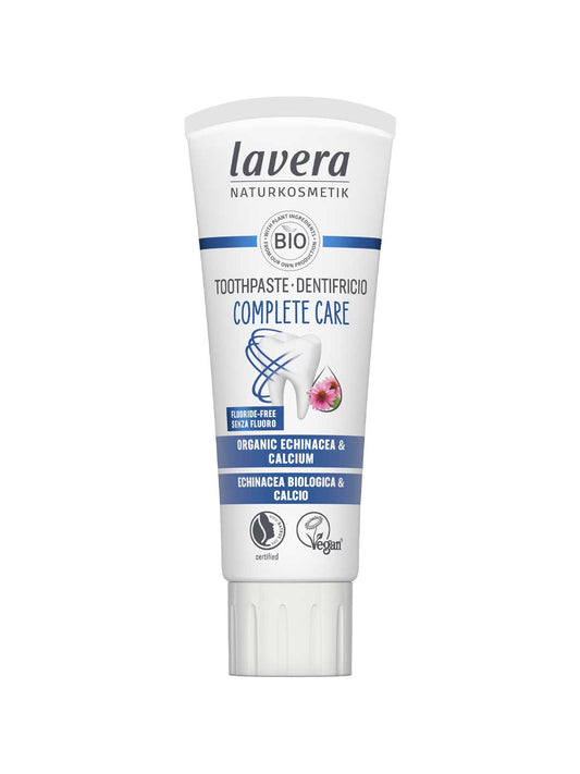 White Lavera Complete Care toothpaste tube with blue bands, a tooth symbol, a small pink flower and a white screw cap.
