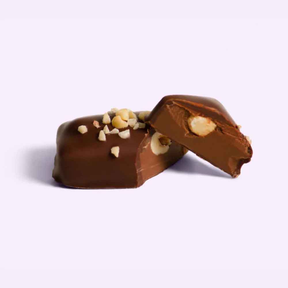 Chocolate-covered candy with nuts on a light purple background