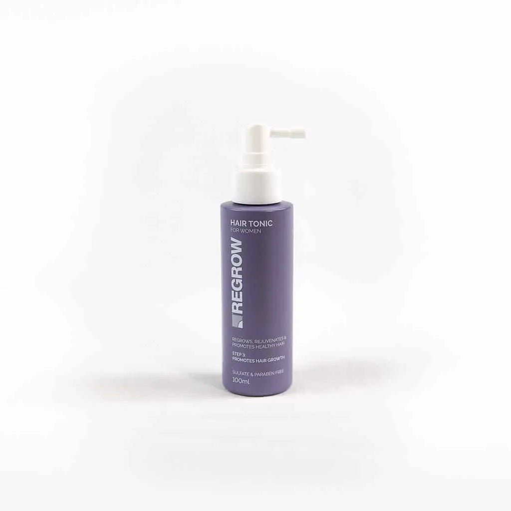 Purple bottle of Regrow hair tonic on a white background