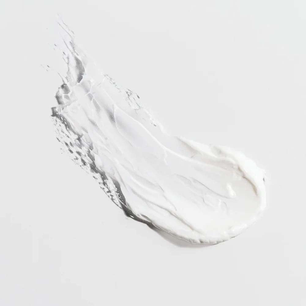 Clear gel or cream smear on a light gray background