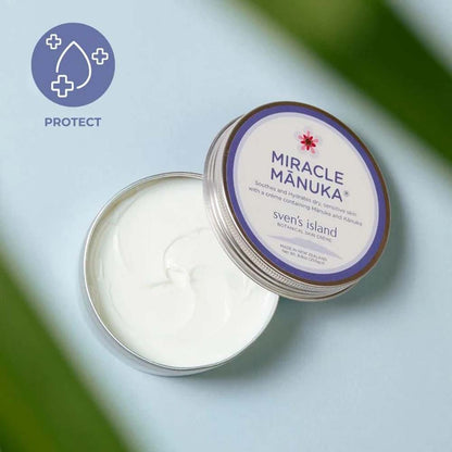 Tin of 'Miracle Manuka' cream with a visible brand label on a light blue background.