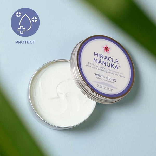 Tin of 'Miracle Manuka' cream with a visible brand label on a light blue background.