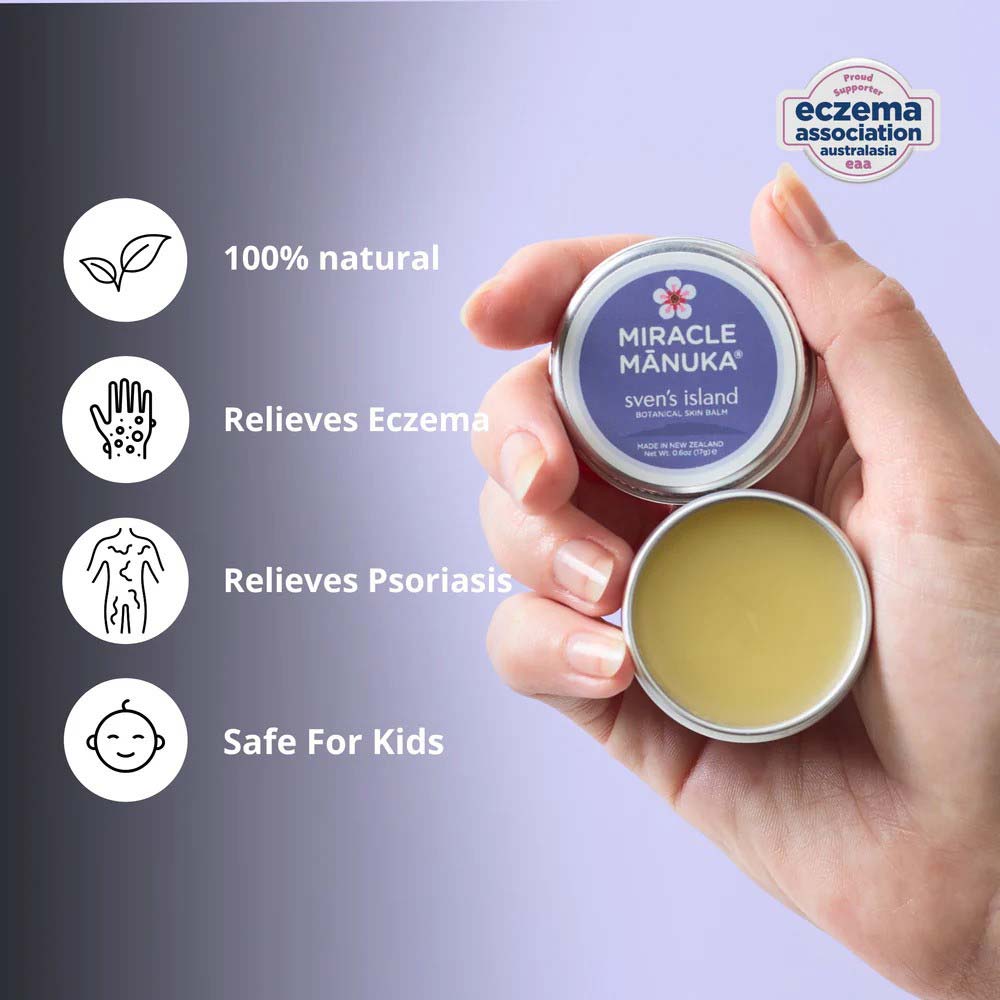 Hand holding a 'Miracle Manuka' balm with product details on a gray background