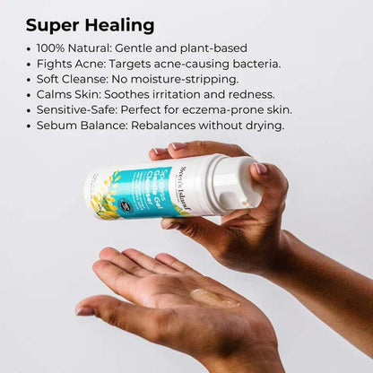 Hand holding a bottle of skincare product with text about its benefits on a light gray background