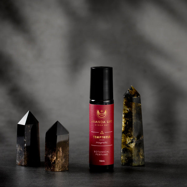 Temptress botanical perfume oil roller with crystals styled fragrance scene