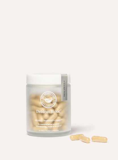 Supplement jar labeled 'Debloat Biotic' with capsules on a white background
