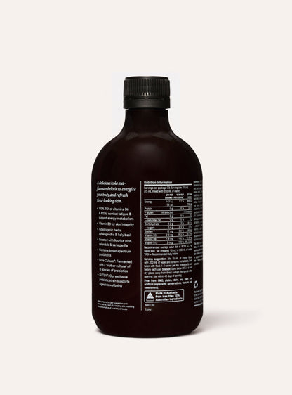 Dark brown bottle of energy boost with nutritional label on a white background