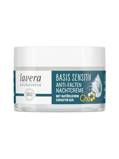 Low clear jar of Lavera Basis Sensitiv Q10 Night Cream with a wide white lid, dark teal label panel, a yellow Q10 mark and blue water droplets.