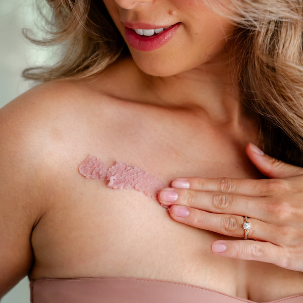 woman applying Mazu body scrub natural exfoliating body scrub for smooth skin