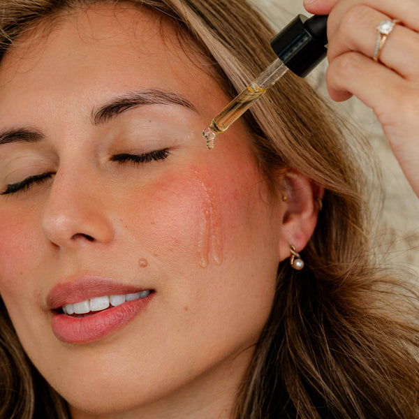 woman applying prickly pear seed facial oil hydrating natural botanical facial oil